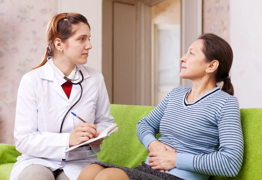 sickness mature woman complaining  to doctor about stitch in side