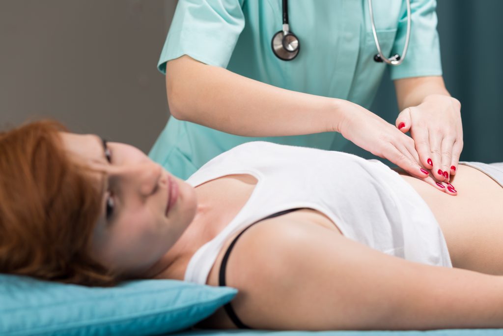 Image of patient with stomach pain and doctor